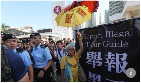 【出典:South China Morning Post(IMAGE:Sam Tsang)】中国本土からの団体観光客へ講義する香港住民